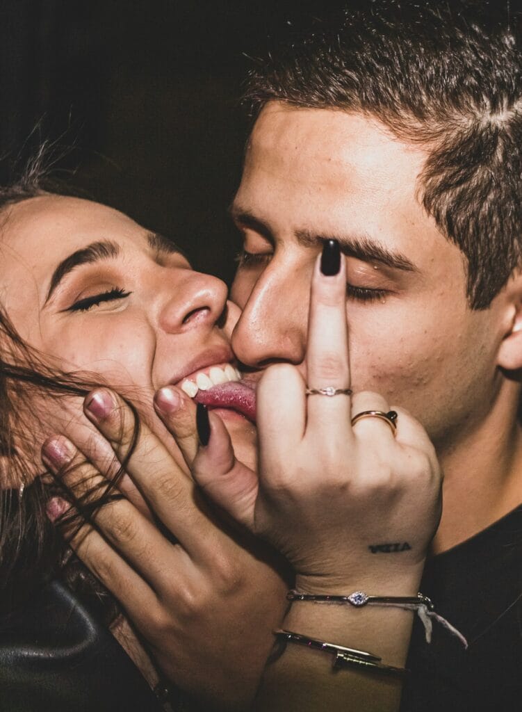 Wild party moment at a Berlin pub crawl and bar hopping night, young women enjoying Berlin nightlife with shots and music