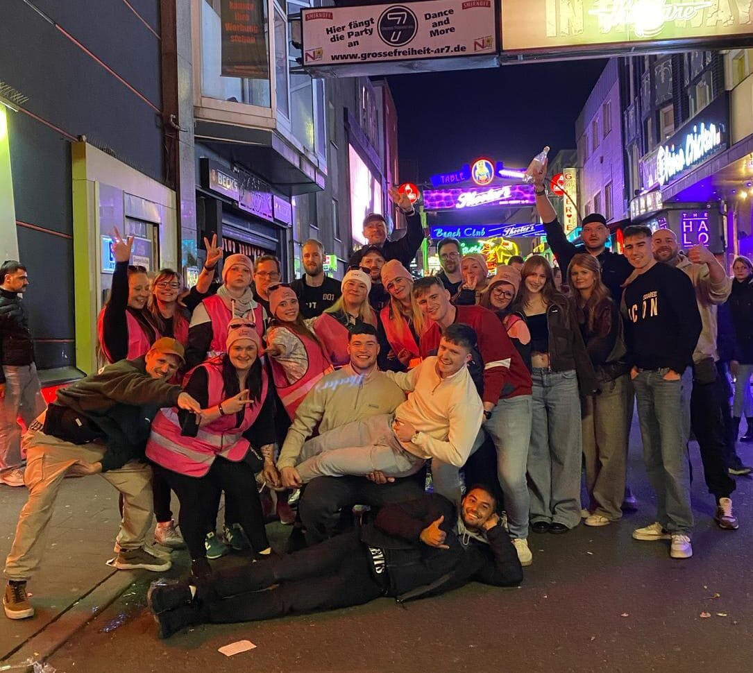 Berlin Bachelor Party Group posing at night on Berlin street – Bartour Berlin nightlife tour